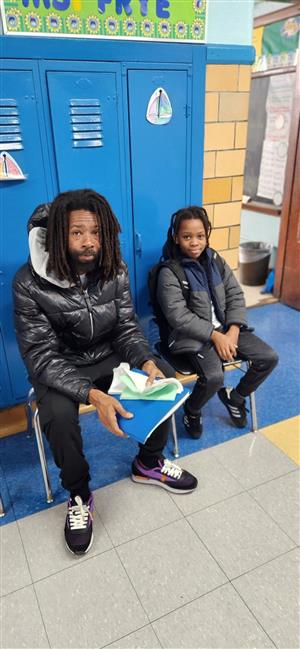 Father and son wait to see teacher